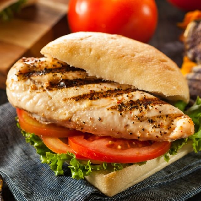 Grilled Chicken Breast Burger on a Bun with Fries.